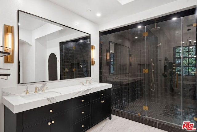 bathroom with vanity and a shower with door