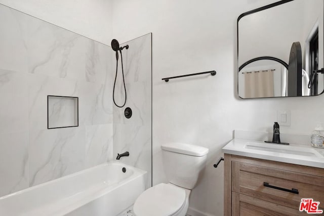 full bathroom with vanity, tiled shower / bath, and toilet