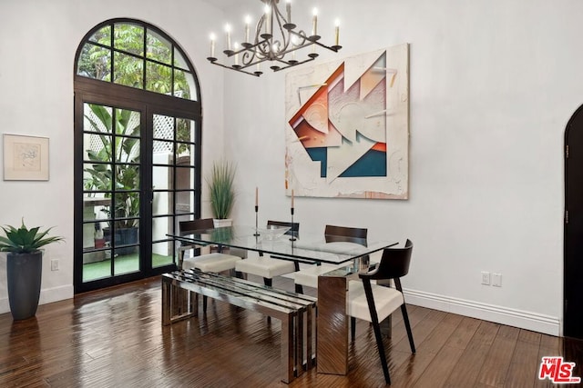 dining space featuring a notable chandelier, dark hardwood / wood-style floors, and french doors