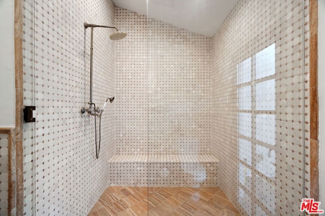 bathroom with an enclosed shower and vaulted ceiling