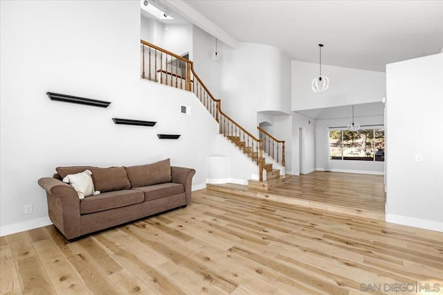 living room featuring hardwood / wood-style flooring and high vaulted ceiling