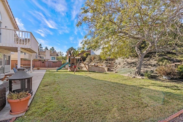 view of yard with a patio area and a playground