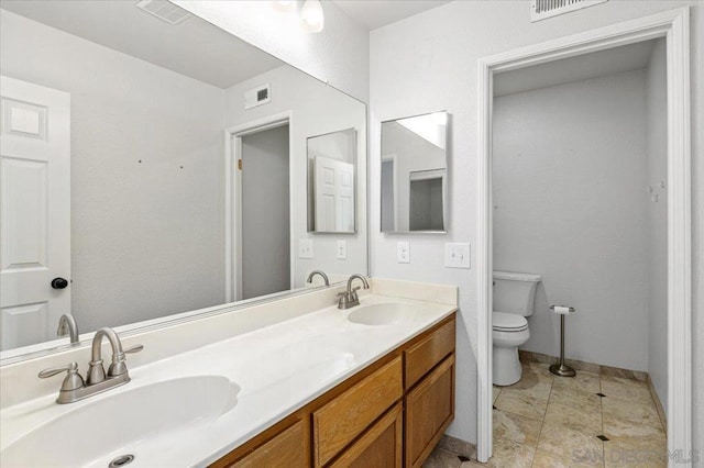 bathroom with vanity, tile patterned floors, and toilet