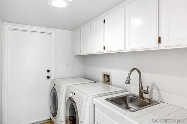 laundry area with sink, cabinets, and washing machine and clothes dryer