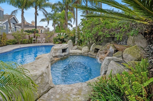 view of swimming pool featuring fence and a fenced in pool