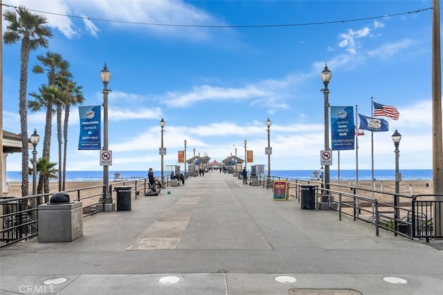 view of street with a water view, street lighting, and traffic signs