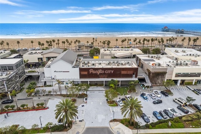 drone / aerial view featuring a water view and a view of the beach