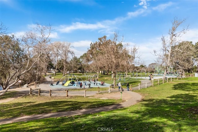 surrounding community featuring playground community and a lawn