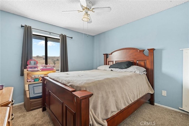 carpeted bedroom featuring ceiling fan and a textured ceiling