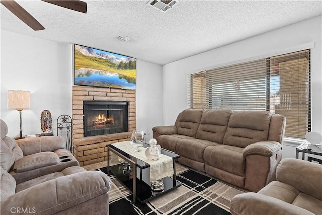 living room with a brick fireplace and a textured ceiling