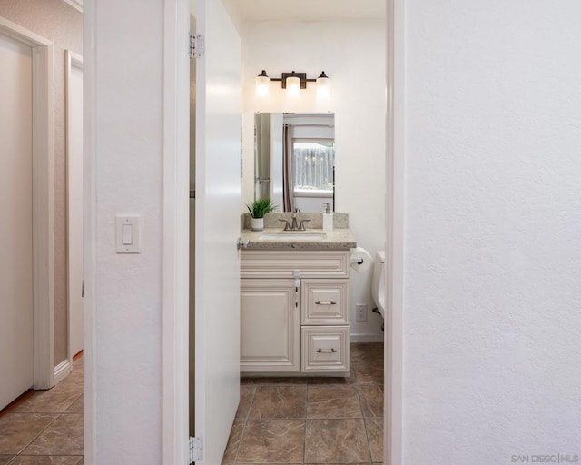 bathroom featuring vanity and toilet