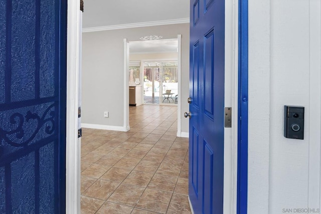 hallway with crown molding and light tile patterned flooring