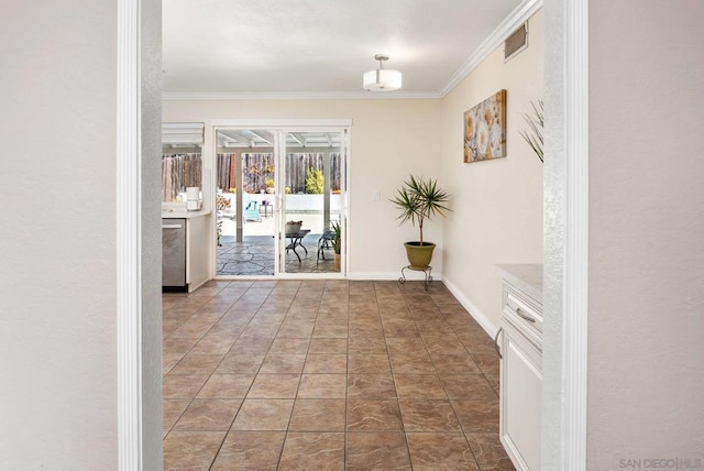 hall featuring dark tile patterned flooring and crown molding