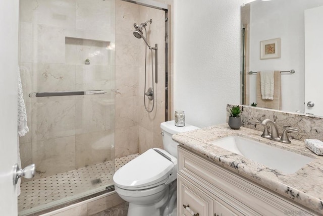 bathroom with toilet, vanity, and walk in shower