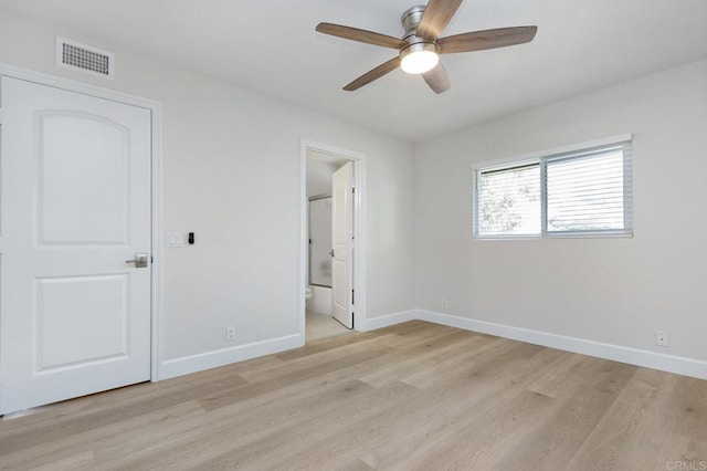 unfurnished bedroom with ceiling fan, ensuite bath, and light hardwood / wood-style flooring