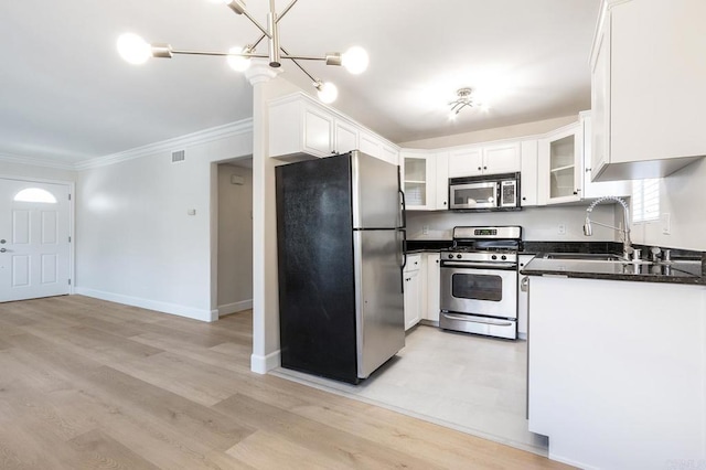 kitchen featuring white cabinetry, ornamental molding, stainless steel appliances, and sink