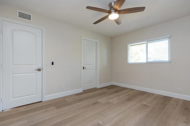 empty room with light hardwood / wood-style floors and ceiling fan