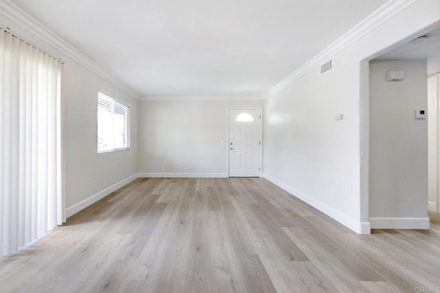 unfurnished room featuring ornamental molding and light hardwood / wood-style floors