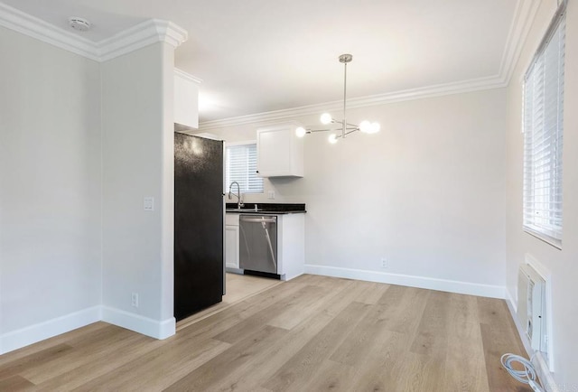 kitchen with crown molding, stainless steel appliances, light hardwood / wood-style floors, a healthy amount of sunlight, and white cabinets