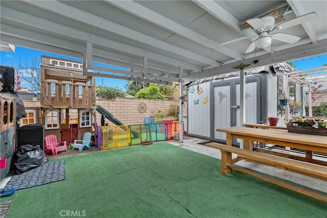 exterior space with ceiling fan and a playground