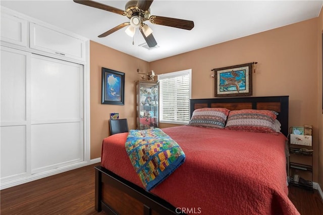 bedroom with dark hardwood / wood-style floors and ceiling fan