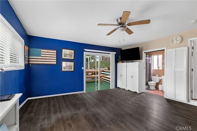 unfurnished room featuring dark wood-type flooring and ceiling fan