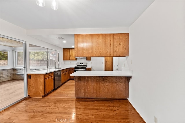 kitchen featuring sink, ventilation hood, kitchen peninsula, stainless steel appliances, and light hardwood / wood-style floors