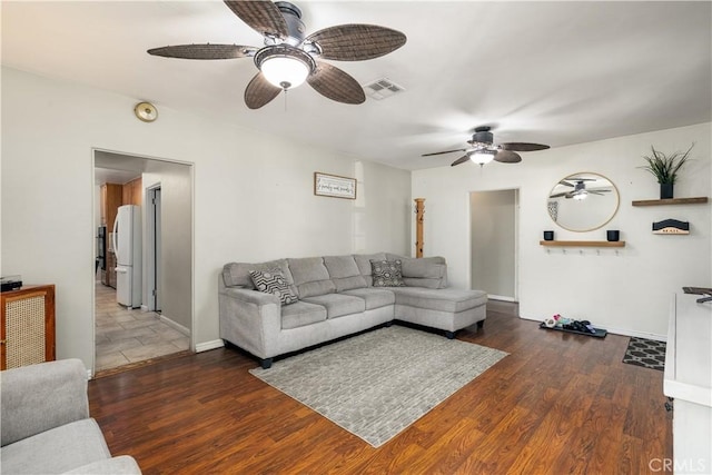 living room with dark hardwood / wood-style floors and ceiling fan