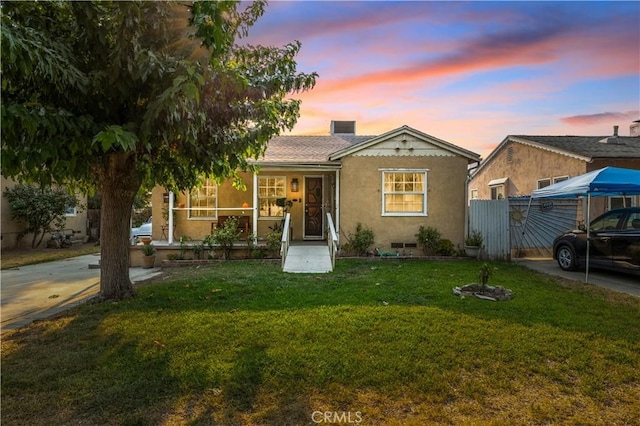 view of front of property with a yard