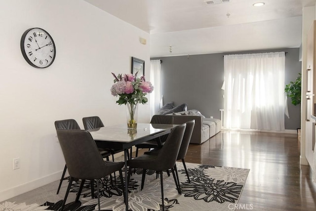 dining space with hardwood / wood-style floors