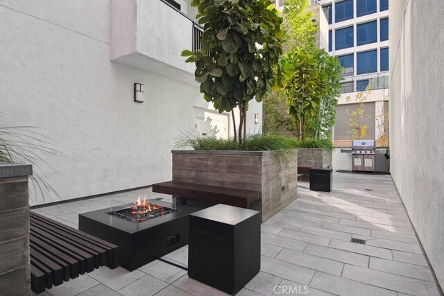 view of patio featuring a fire pit and grilling area