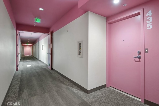 hallway featuring dark colored carpet