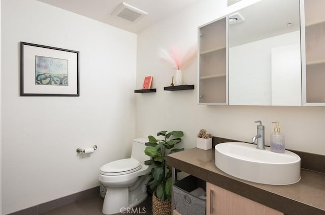 bathroom featuring vanity and toilet