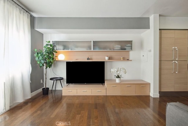 unfurnished living room featuring dark wood-type flooring