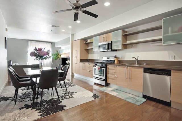 kitchen with stainless steel appliances, dark hardwood / wood-style flooring, sink, and light brown cabinets