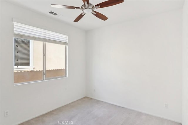 carpeted spare room with ceiling fan