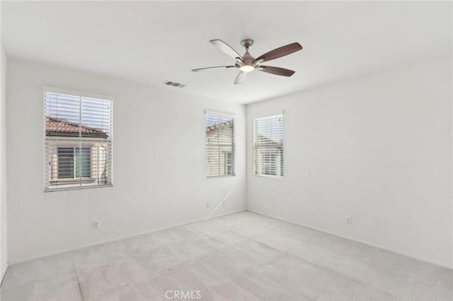 spare room with light carpet and ceiling fan