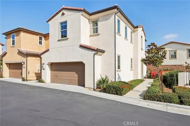 mediterranean / spanish home featuring a garage