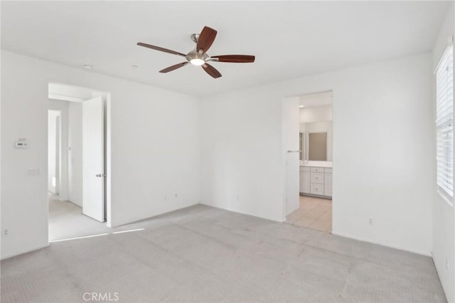 carpeted spare room featuring ceiling fan