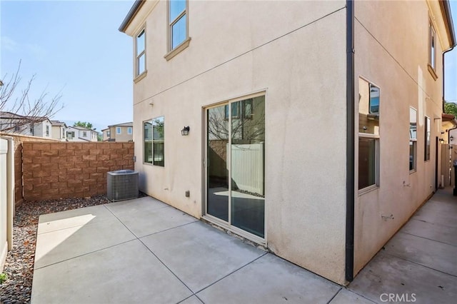 view of home's exterior with cooling unit and a patio