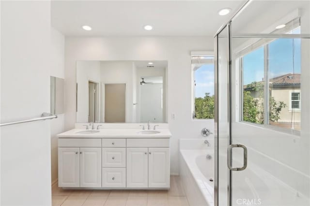 bathroom featuring vanity, tile patterned flooring, shower with separate bathtub, and ceiling fan