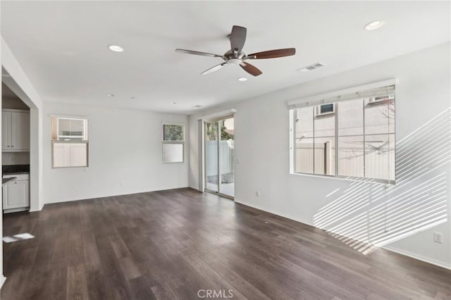 unfurnished living room featuring ceiling fan and dark hardwood / wood-style flooring