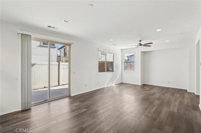 spare room with ceiling fan and dark hardwood / wood-style flooring