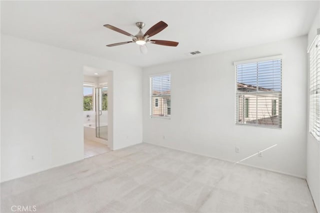 carpeted empty room featuring ceiling fan