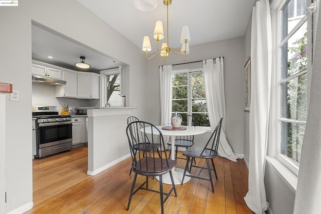 dining room with a chandelier and light wood-type flooring