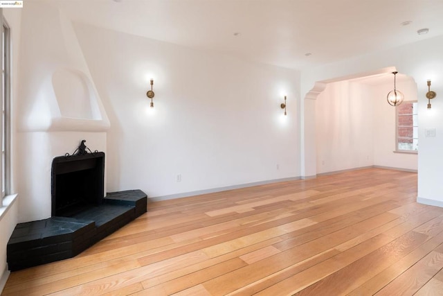 unfurnished living room featuring hardwood / wood-style flooring