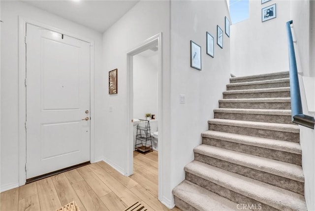 foyer entrance with light hardwood / wood-style floors