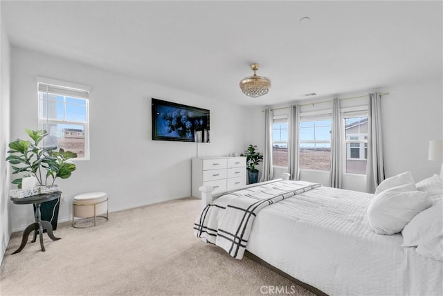 carpeted bedroom with multiple windows