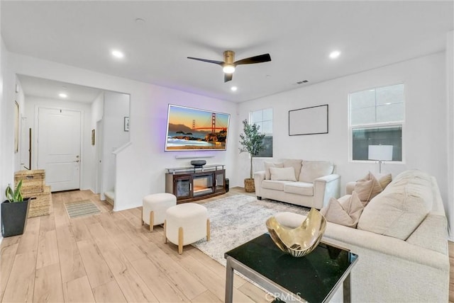 living room featuring recessed lighting, light wood-type flooring, visible vents, and a ceiling fan