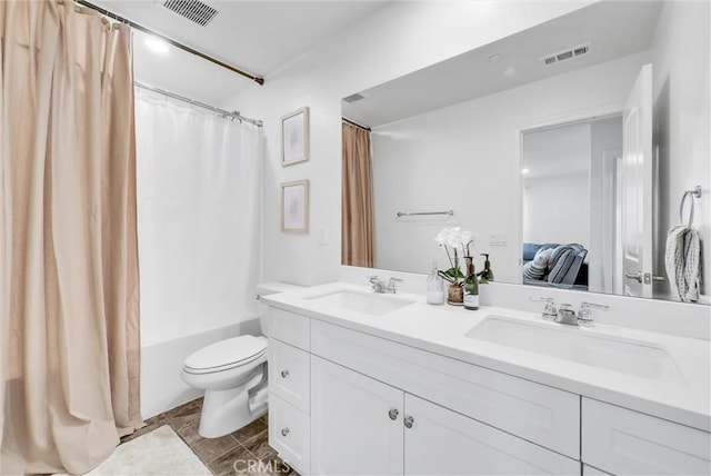 bathroom with visible vents, toilet, and a sink